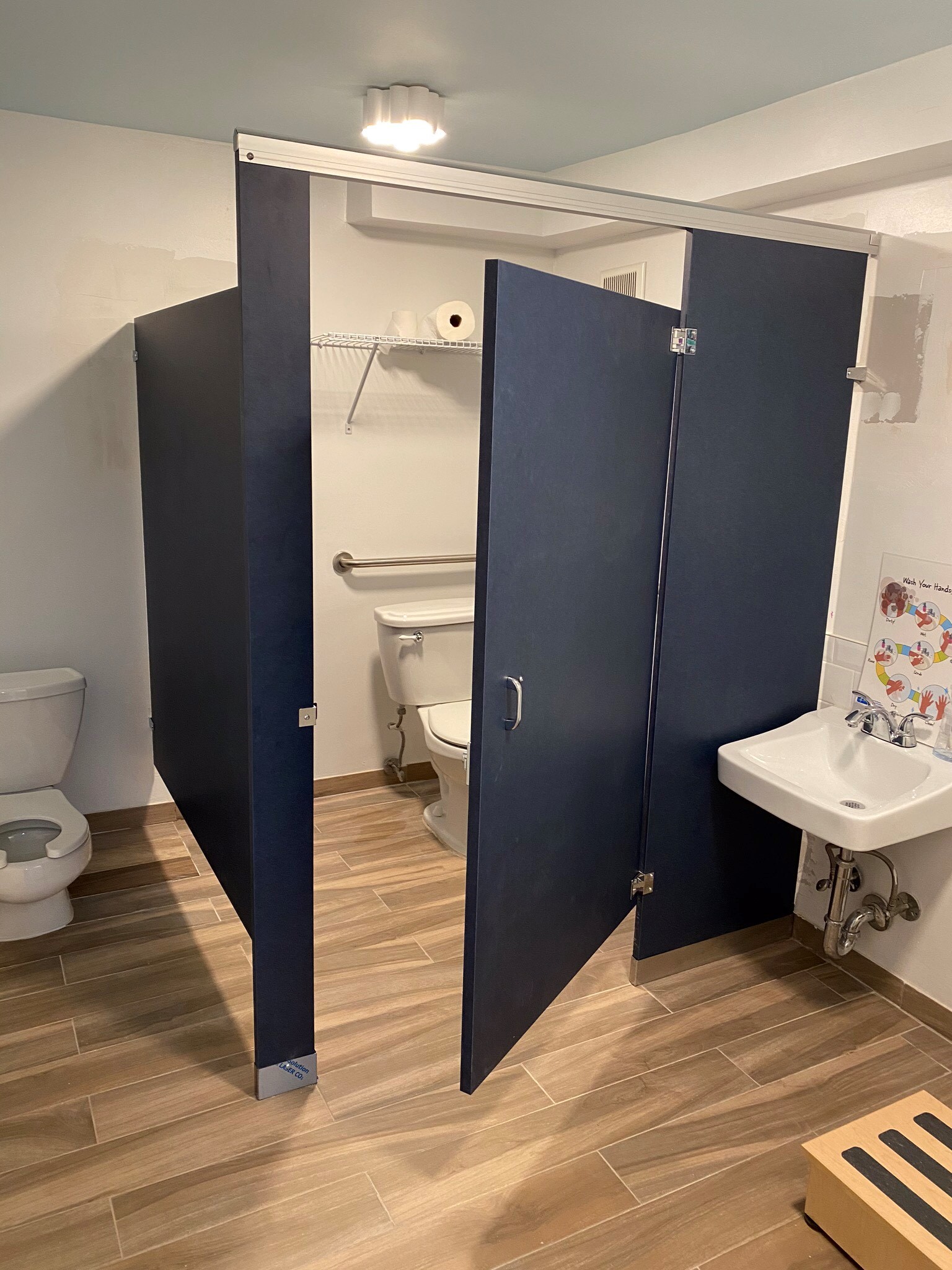 Dark blue navy bathroom stall design